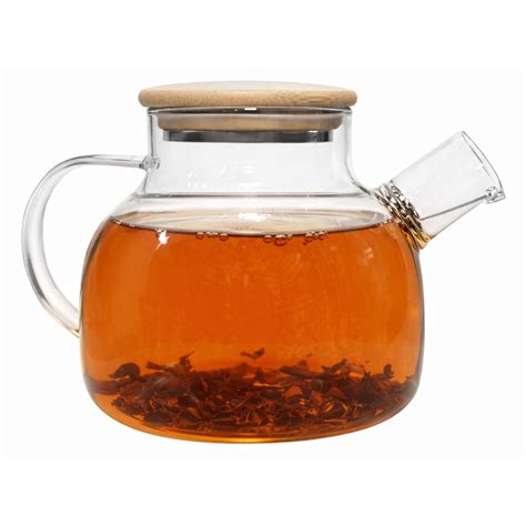 Átlátszó üveg teáskanna tealevelekkel